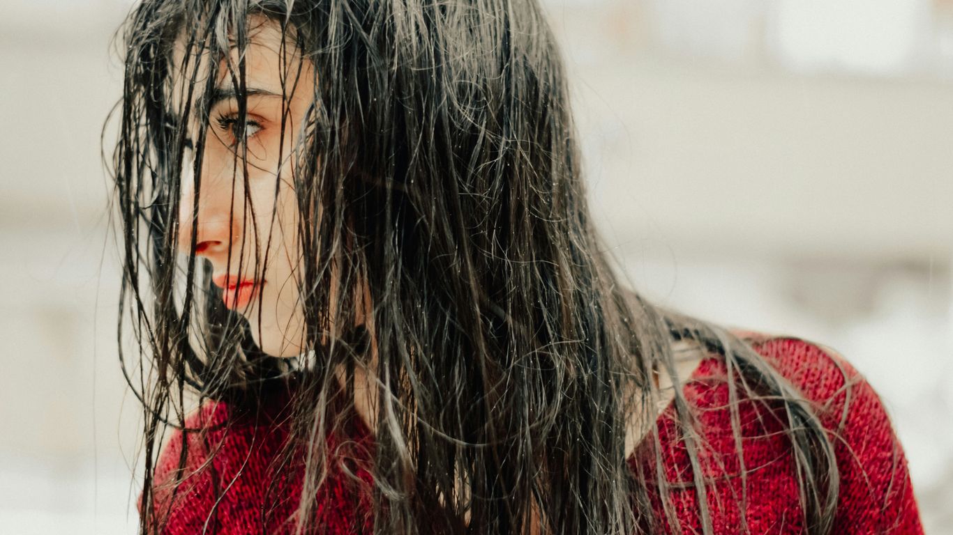 A close up of a woman with wet hair