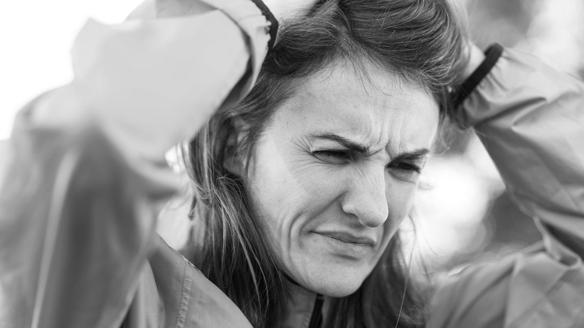 a woman holding her head in her hands